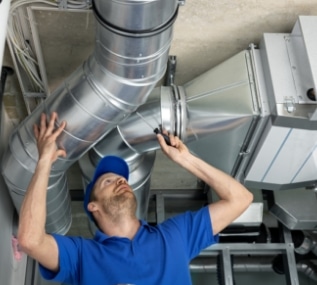 hvac technician installing custom duct work